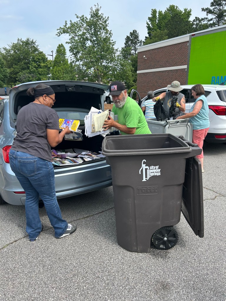Staff unloading documents for shredding on Shred Day.